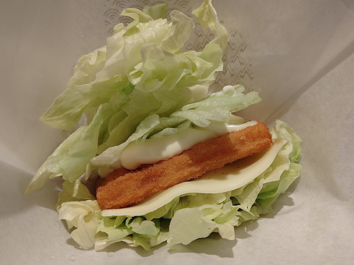 Crisp fish fillet with a slice of cheese and creamy sauce wrapped in fresh iceberg lettuce leaves