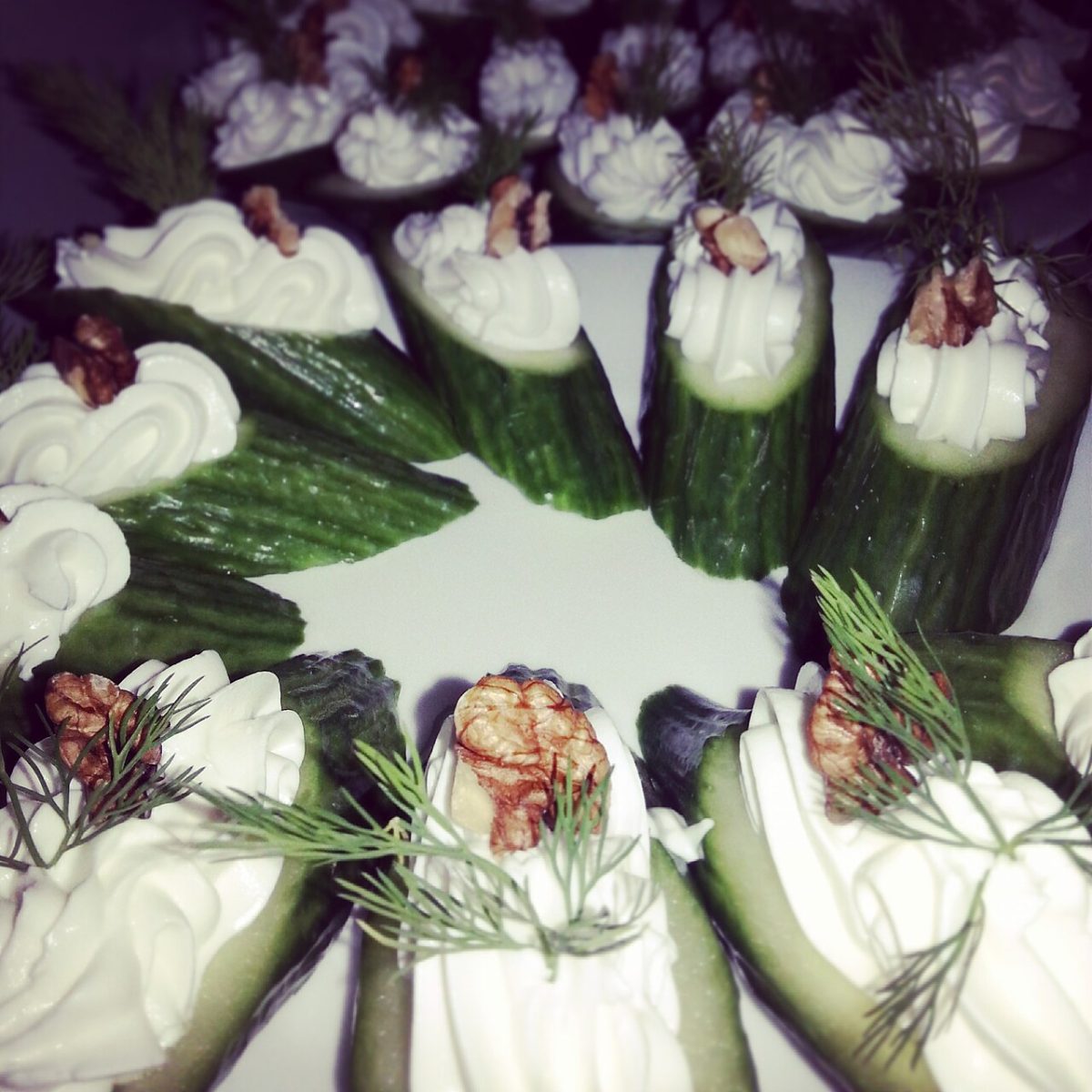 Cucumber pieces topped with piped cream cheese, fresh dill and walnut halves