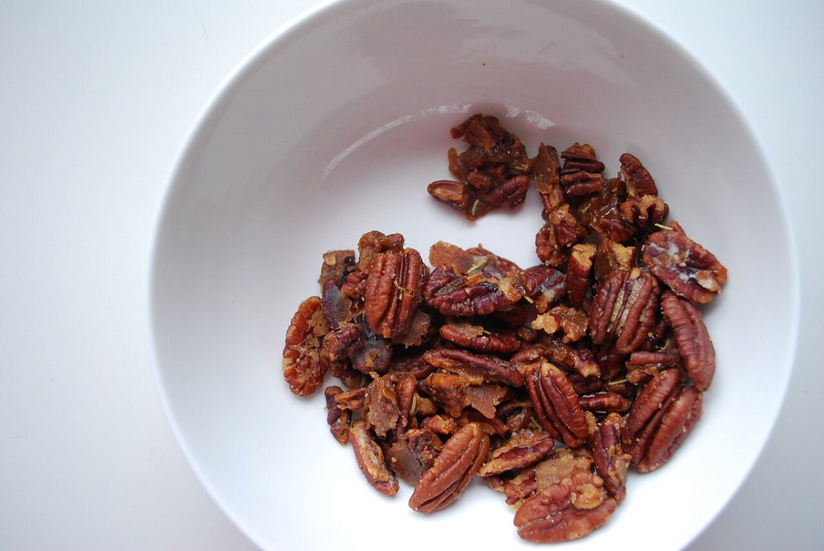 Glazed rosemary pecans in a white bowl